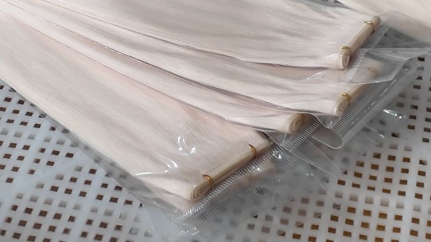 hair extensions being packaged in plastic bags