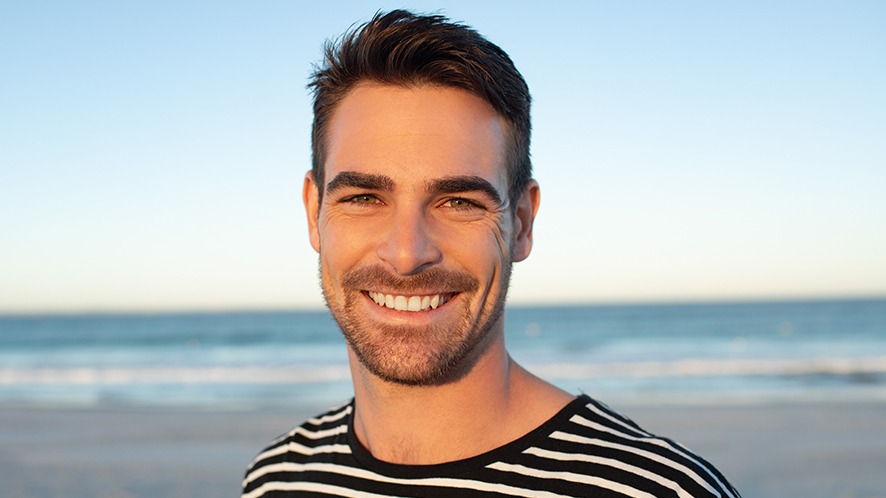 a man wearing hair system smiling