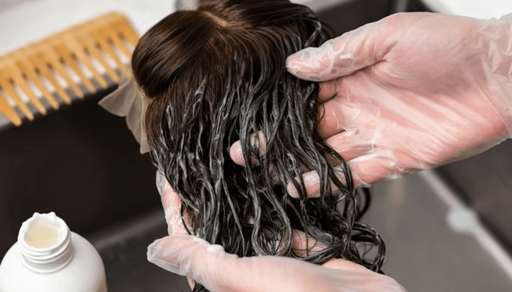 applying hair conditioner on the middle and ends of a human hair wig