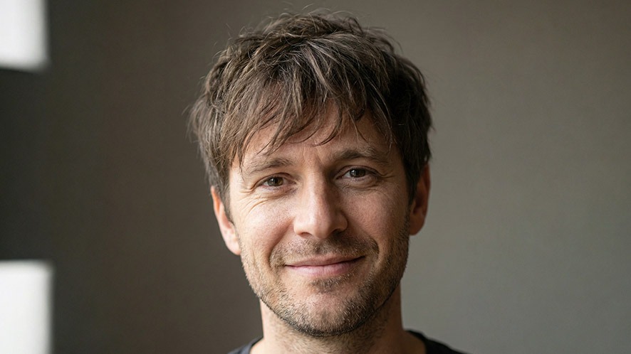 Close-up of a man’s boy bangs hairstyle showing natural loose texture