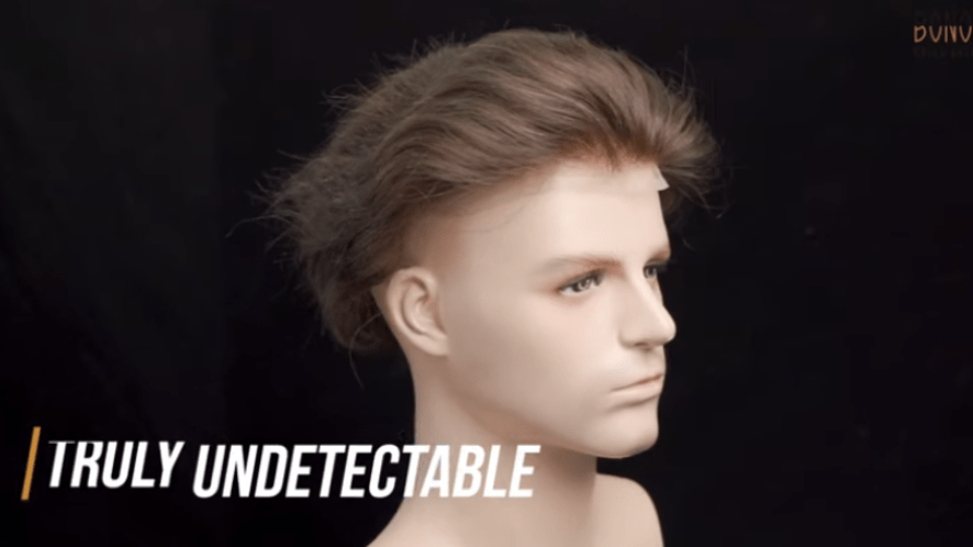 A men's lace toupee on a mannequin head with "Truly Undetectable" text.