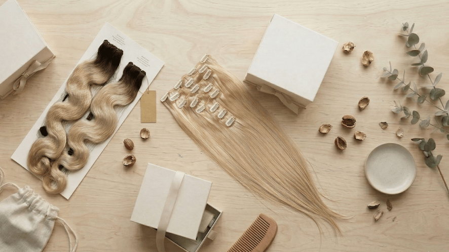 Bono private label hair extensions (Genius Wefts & Clip-ins) lying on a desk