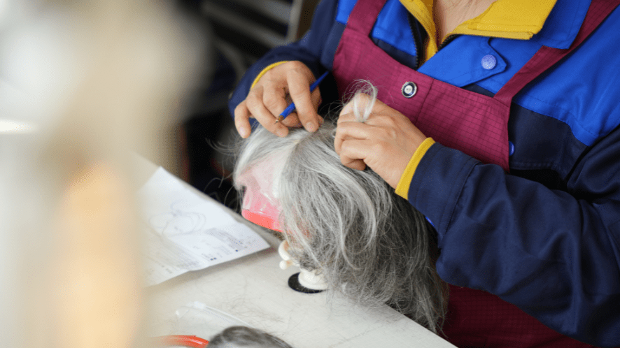 ventilating worker knotting the hair to the base