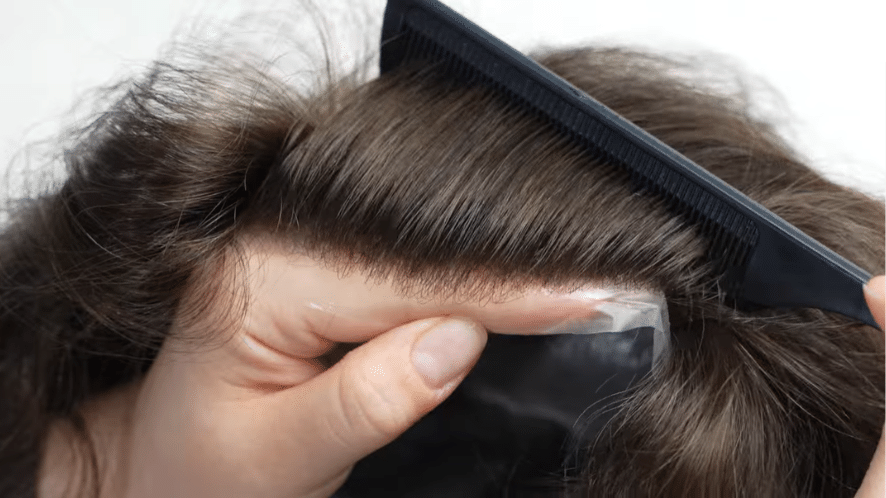 checking the front hairline of a men's hair piece