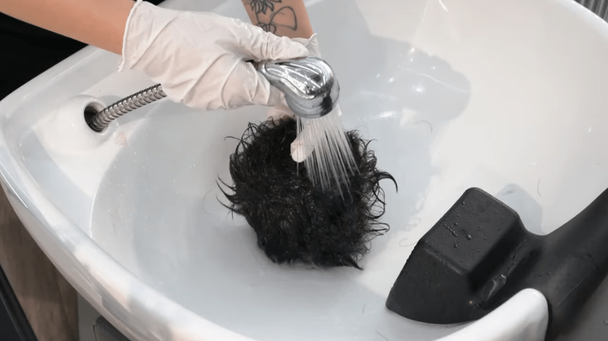 rinsing the hair conditioner out of the hair piece